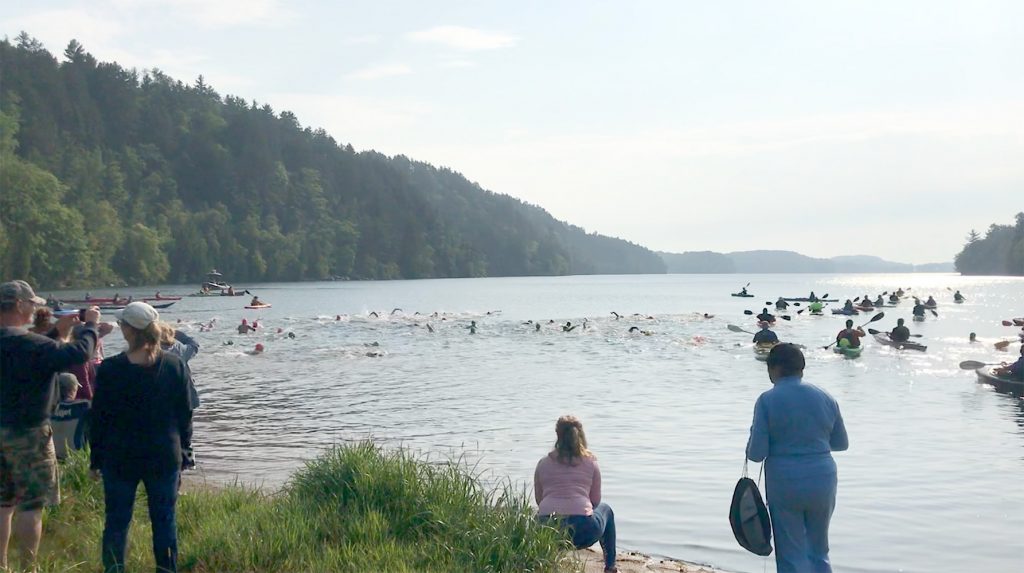 Swimmers In Teal Lake